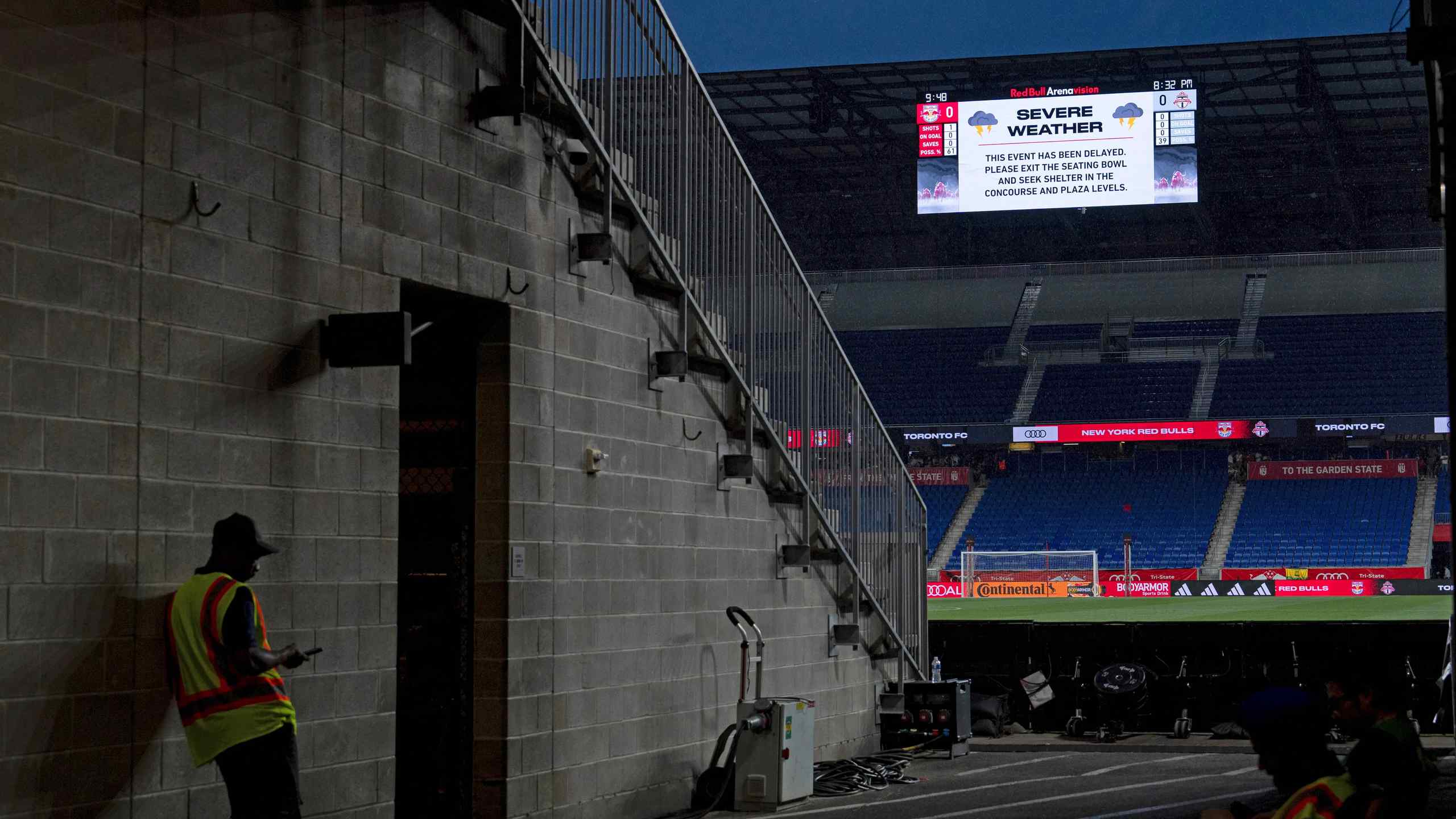 A stadium going through a weather delay, which is displayed on the jumbotron
